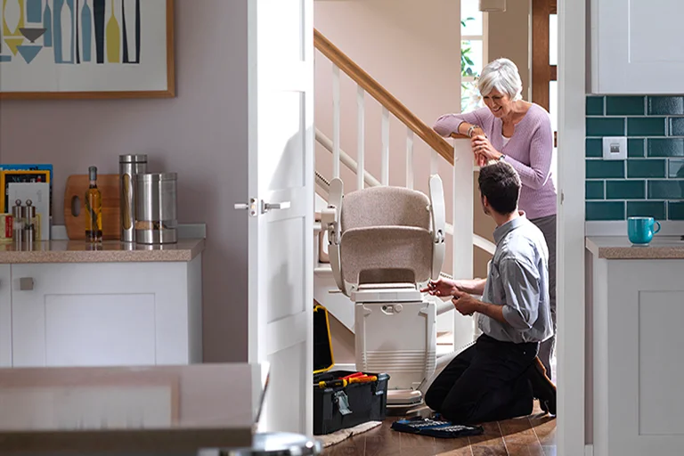 A Stannah service engineer maintaining a stairlift