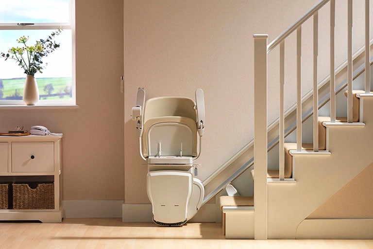 stairlift on staircase with sofa in background