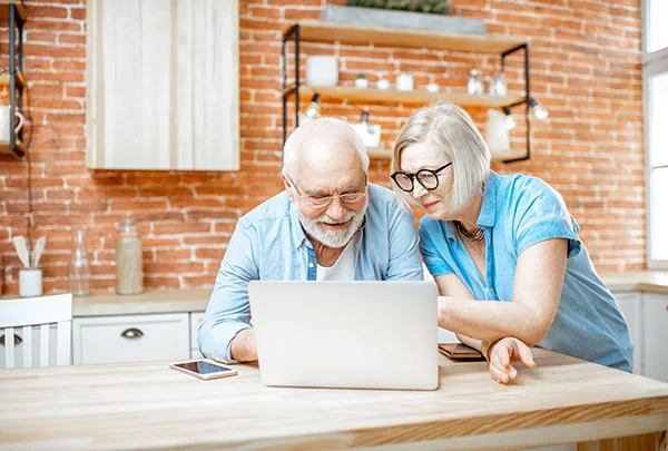 AdobeStock couple on laptop s A Stannah engineer is inspecting a stair lift