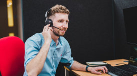 man with a headset at a desk