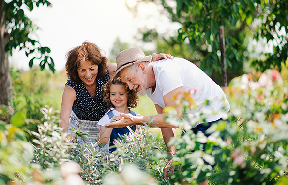 couple with child in garden with flowers
