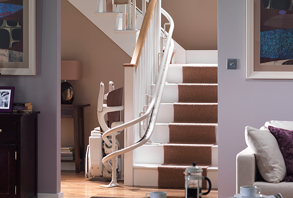 stairlift on inside at bottom of stairs with carpet runner
