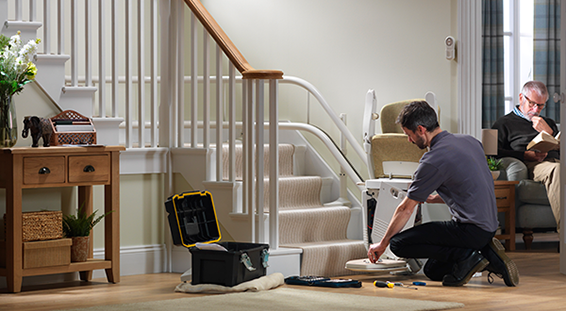 Man with tools fixing stairlift