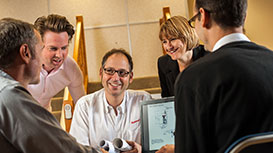 group of people around a table with computer